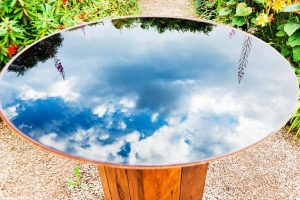 The beautiful reflection of the sky can be seen on this reflecting pool bird bath